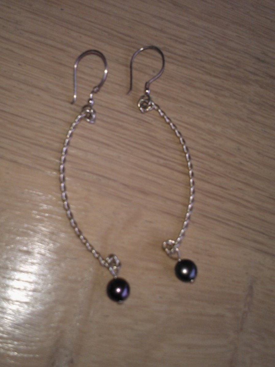Figure 10 Lange oorbellen (vanaf het haakje iets meer dan 7 cm.) van echt zilver met zoetwaterpareltje € 10,00.